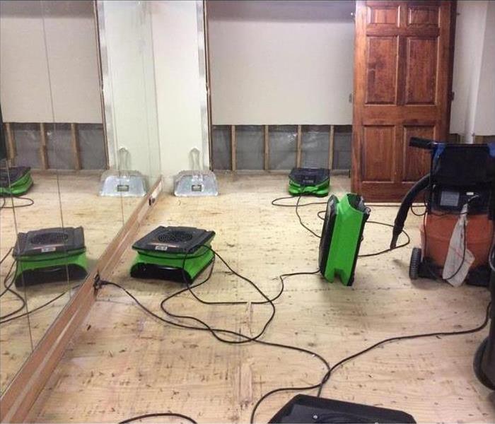 A room with floors torn up due to water damage in Toledo